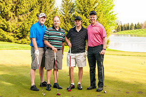 Four male golfers posing