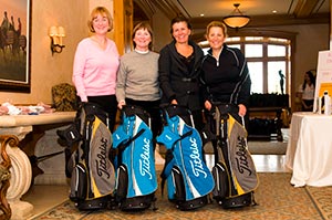 golfers posing with golf bags