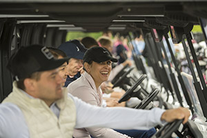 A row of golf carts with golfers seated