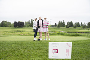Three golfers stand for a photo