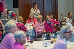 Larger group of golfers sitting at tables in a banquet hall