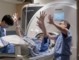 Chris in MRI with Clement – holding fingers open spread up in the air.