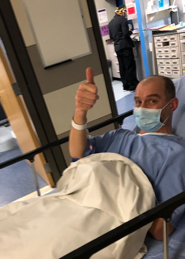 Jon Kay in hospital bed