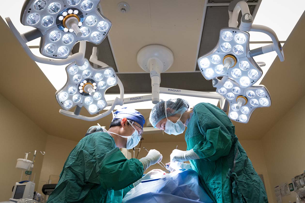 Two doctors perform surgery on a patient