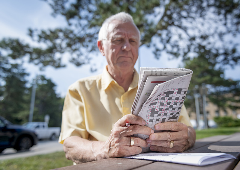 David Hillyar reads the newpaper in a park