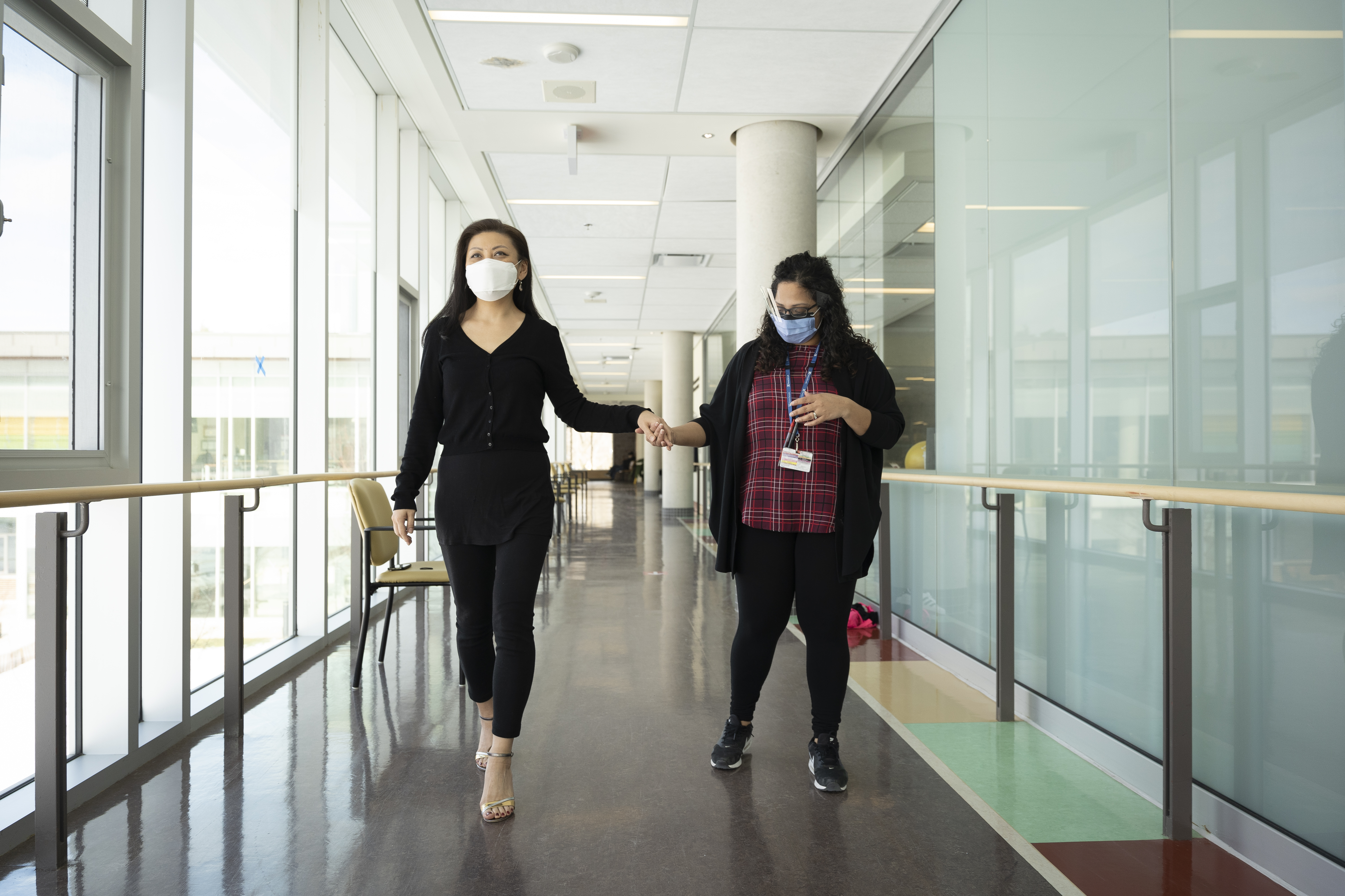 Jenny Shin walks a hospital hallway in high heels