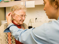 Woman getting hearing aid fitted