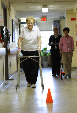 Shirley walking towards an orange pylon during a walk test