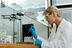 female researcher at lab bench conducting experiment