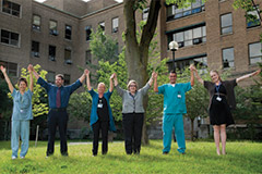 Sunnybrook staff cheering and holding hands