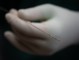Interesting shot of electrode – tip in focus with gloved hand blurred in background