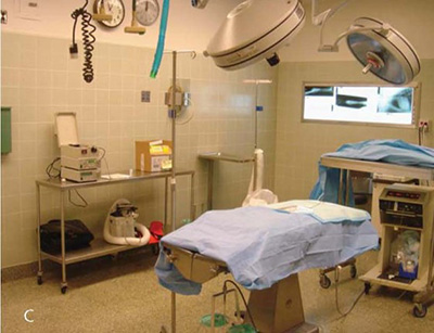 A room in a clinic with equipment and a hospital bed.