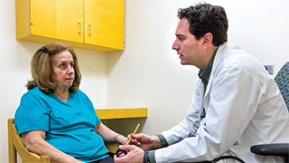Dr. Lorne Zinman talks with his patient