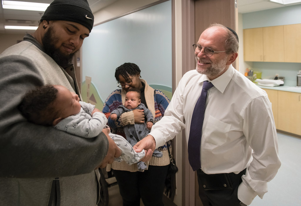 Dr. Jon Barrett, with twins Onyx and Nasir Anderson-John, and their parents.