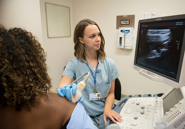 Woman receiving ultrasound on shoulder