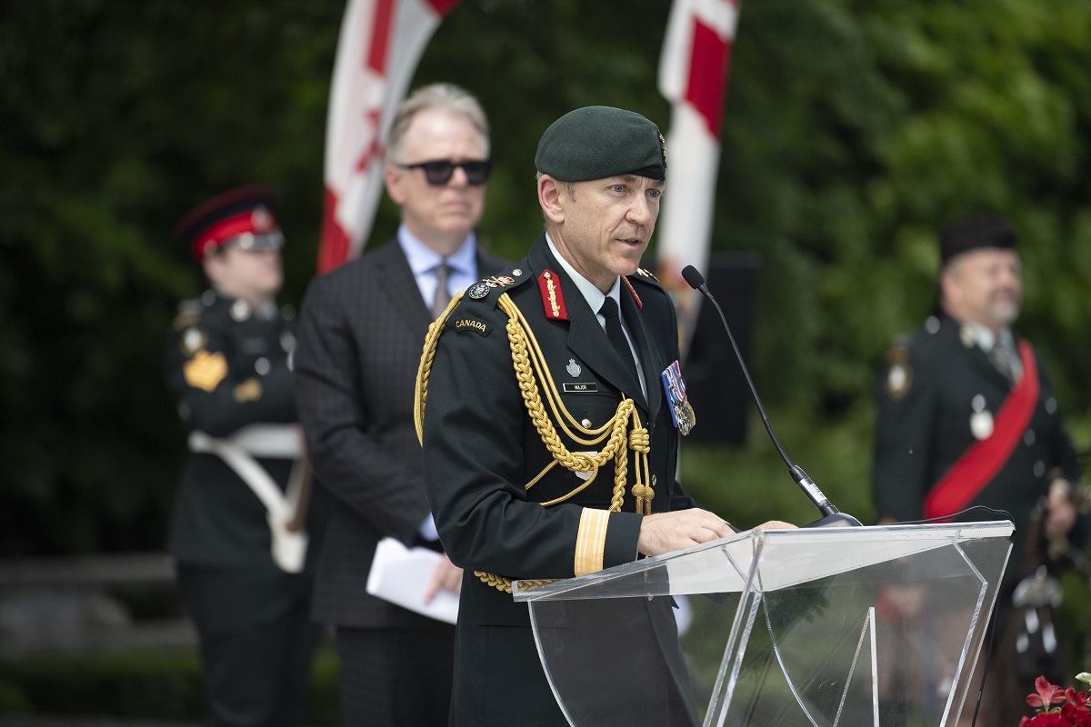 A Canadian veteran speaks at a podium