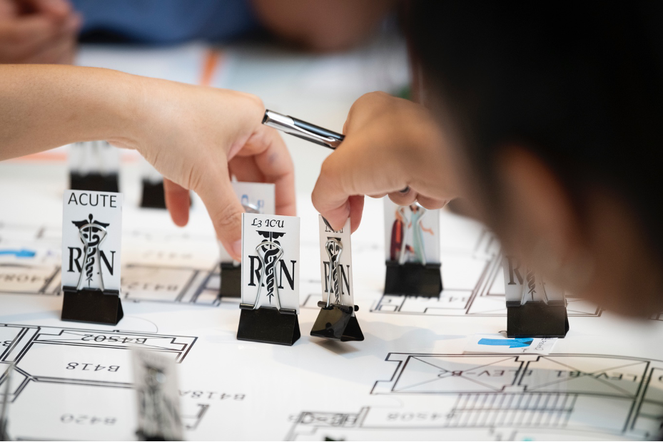 Sunnybrook staff using the movable pieces on the game board during the mock exercise.