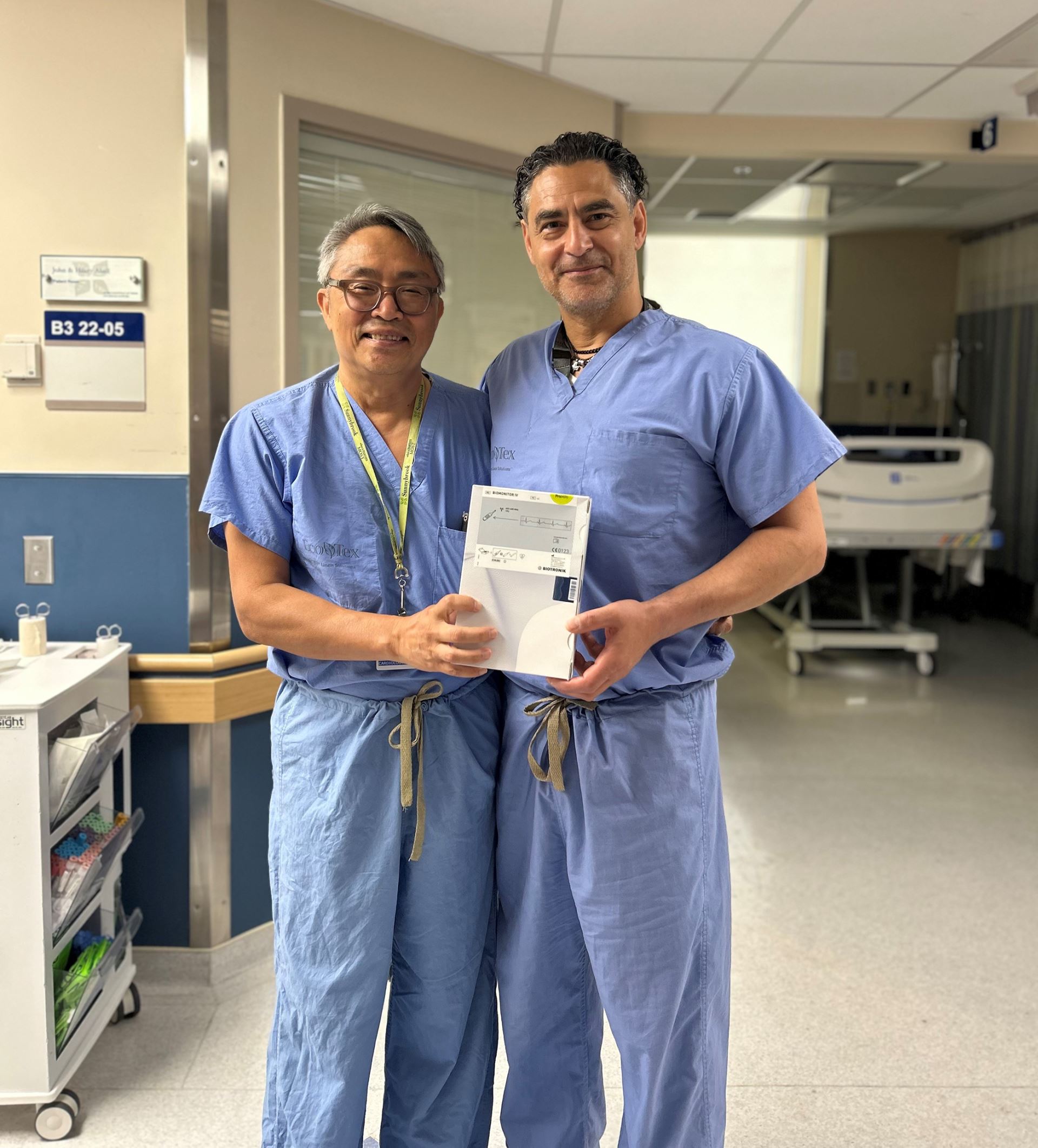 Doctor Lau and Doctor Moussa stand together in a hallway at Sunnybrook hospital