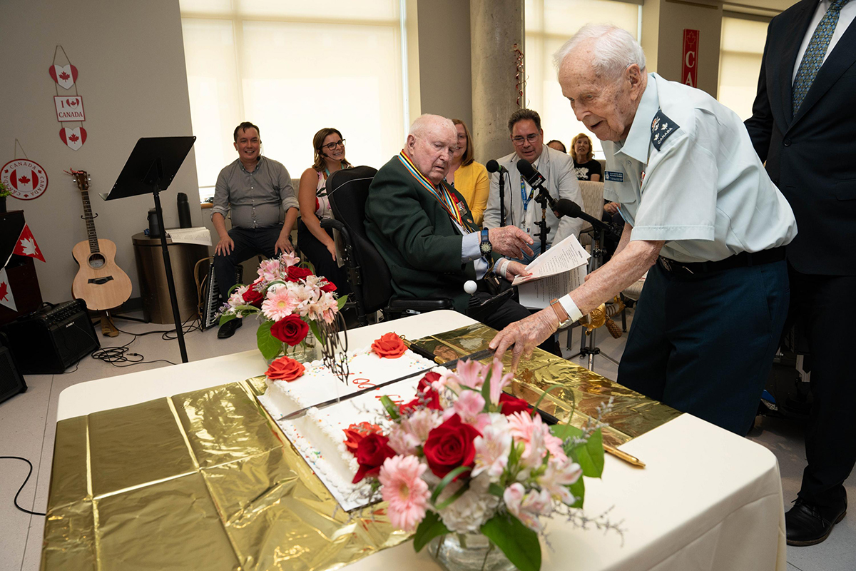 General Richard Rohmer, age 101, cut the first slice of cake with a ceremonial sword