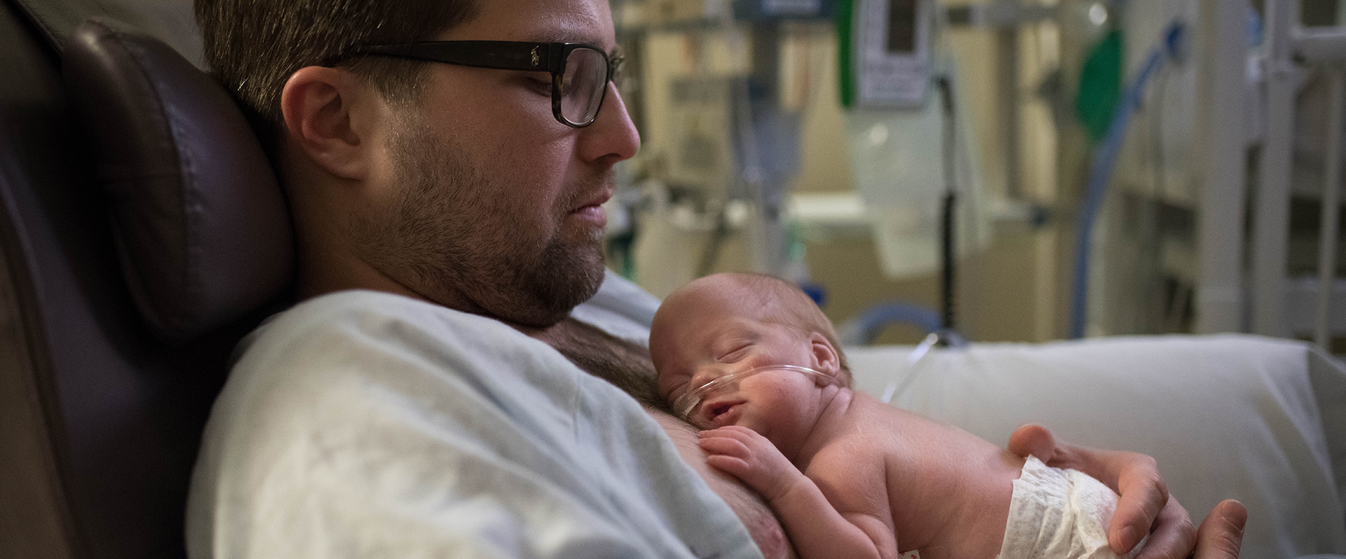 Dad and baby in NICU