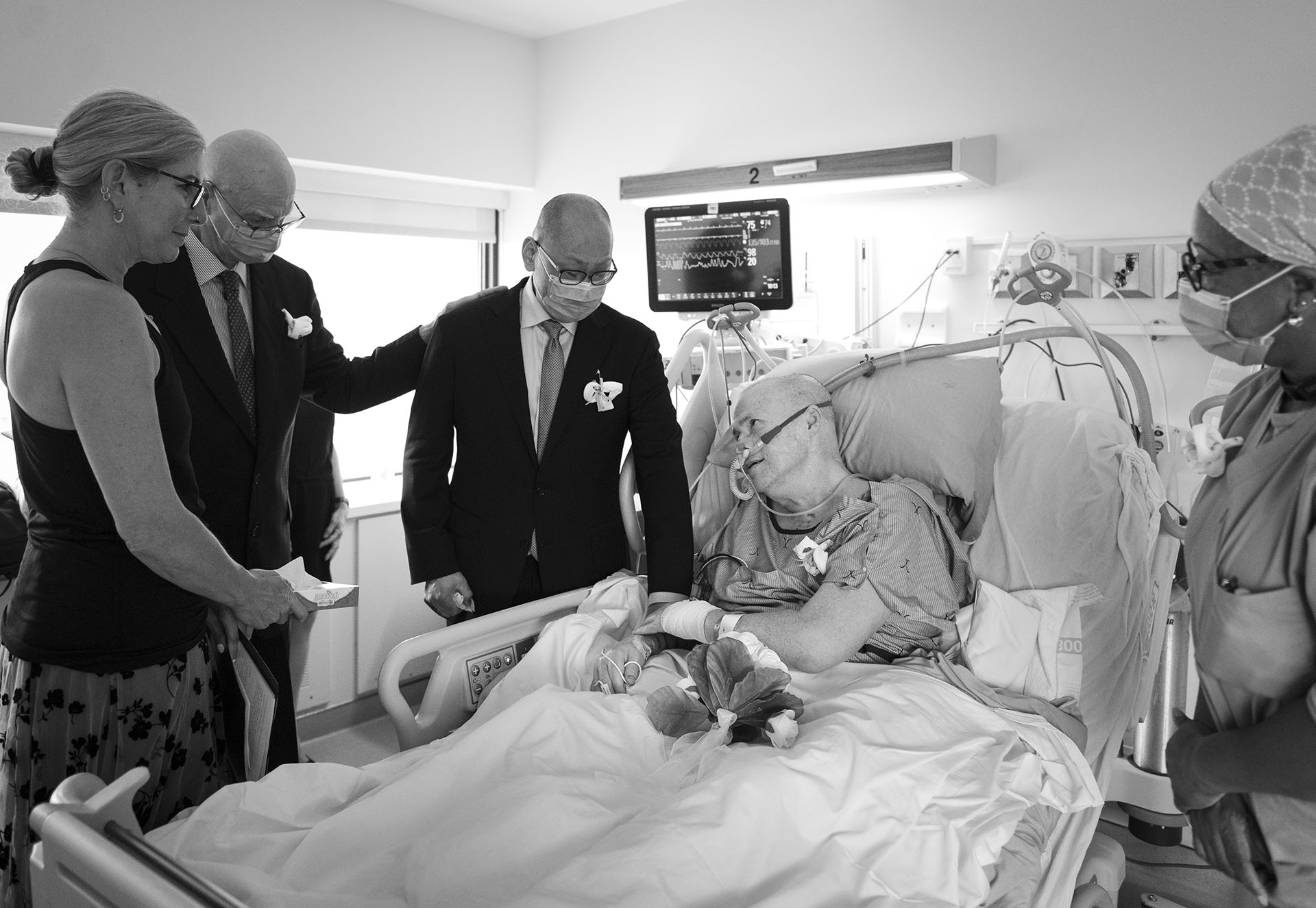 Van, Andrew, Lainie and Sybil standing by Ron in the ICU bed.