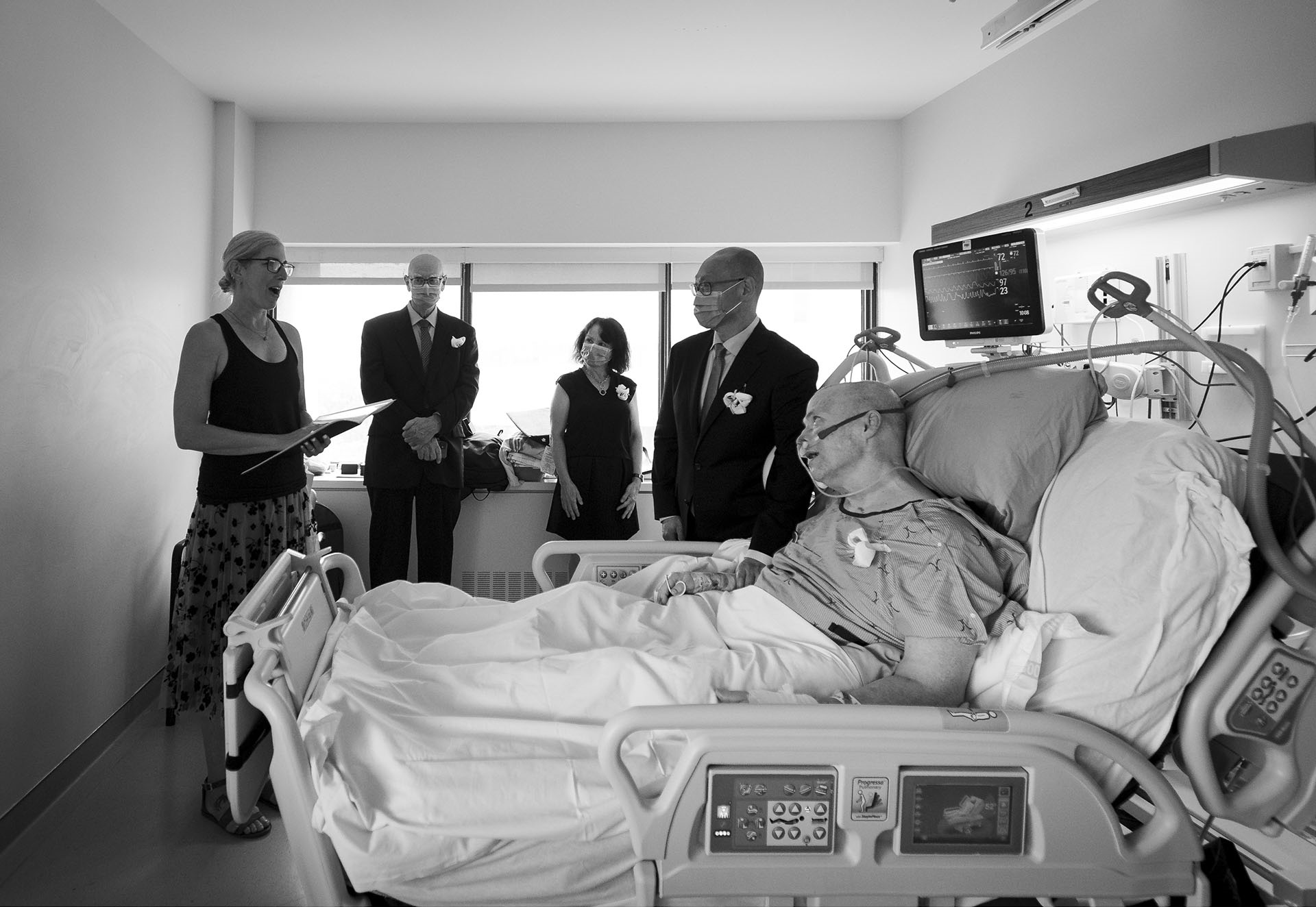 Van, Andrew, Lainie and Florence standing by Ron in the ICU bed.