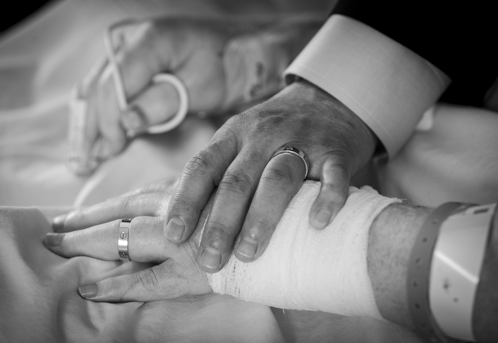 Close-up of Ron and Van’s hands together showing the newlyweds rings.