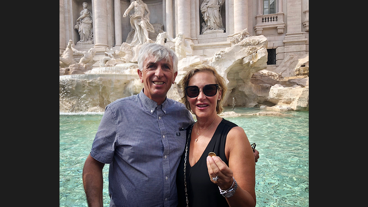 Debbie and her husband at Trevi fountain