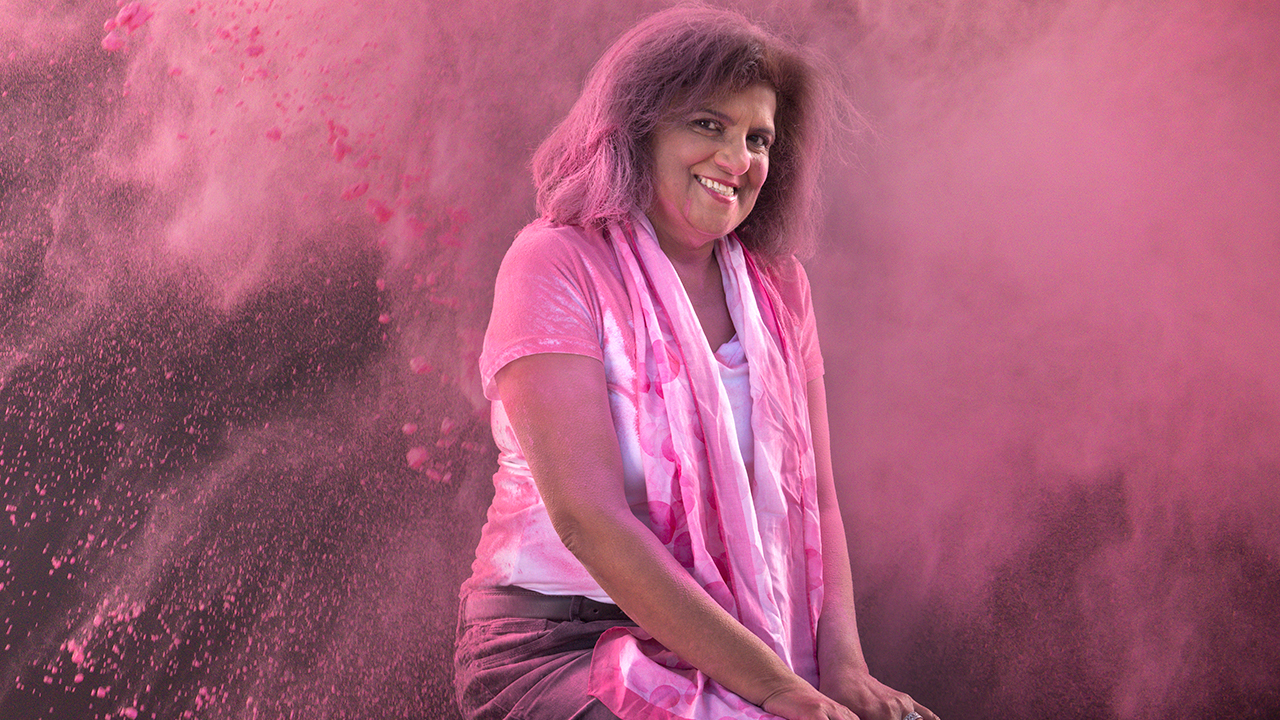 Karima sitting amidst pink powder