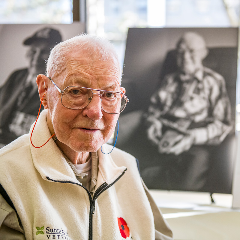 Sunnybrook Veteran smiles with his portrait.