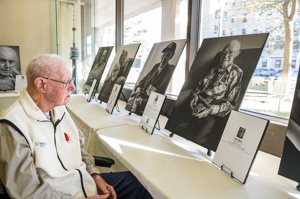 A veteran looks at a portrait of himself.