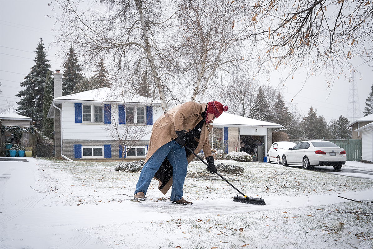 George shovels a sidewalk