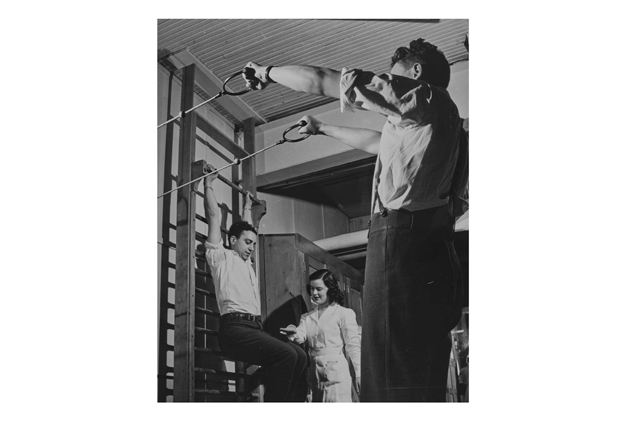 Veterans performing rehabilitation exercises. 1950-60.