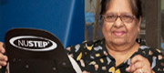One of our patients works out in our gym, with help from Geriatric Services staff.